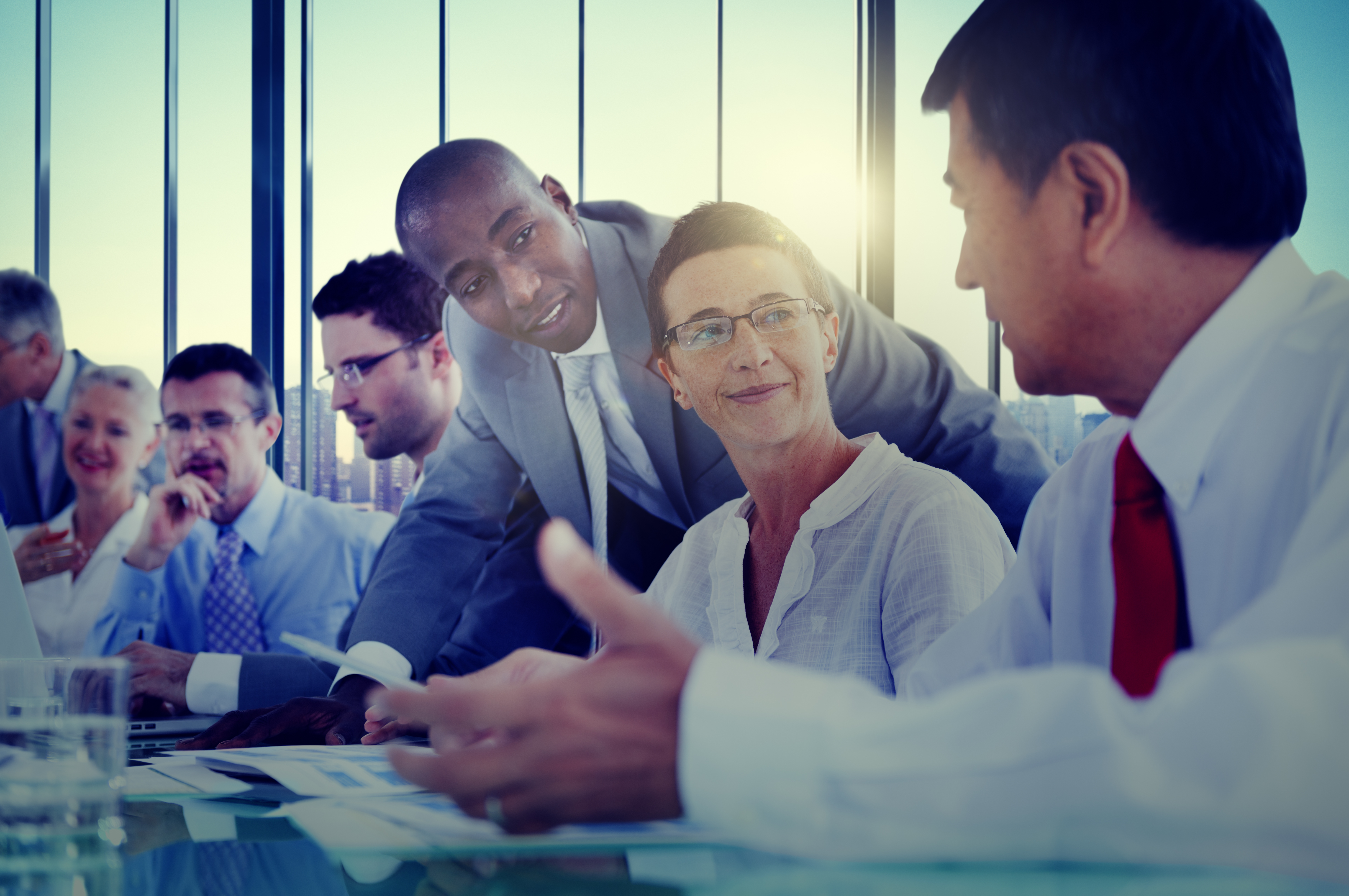 Group of adults in office setting in discussion 